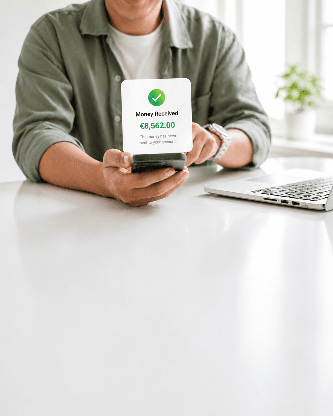 A person holding a phone showing a 'Money Received' confirmation